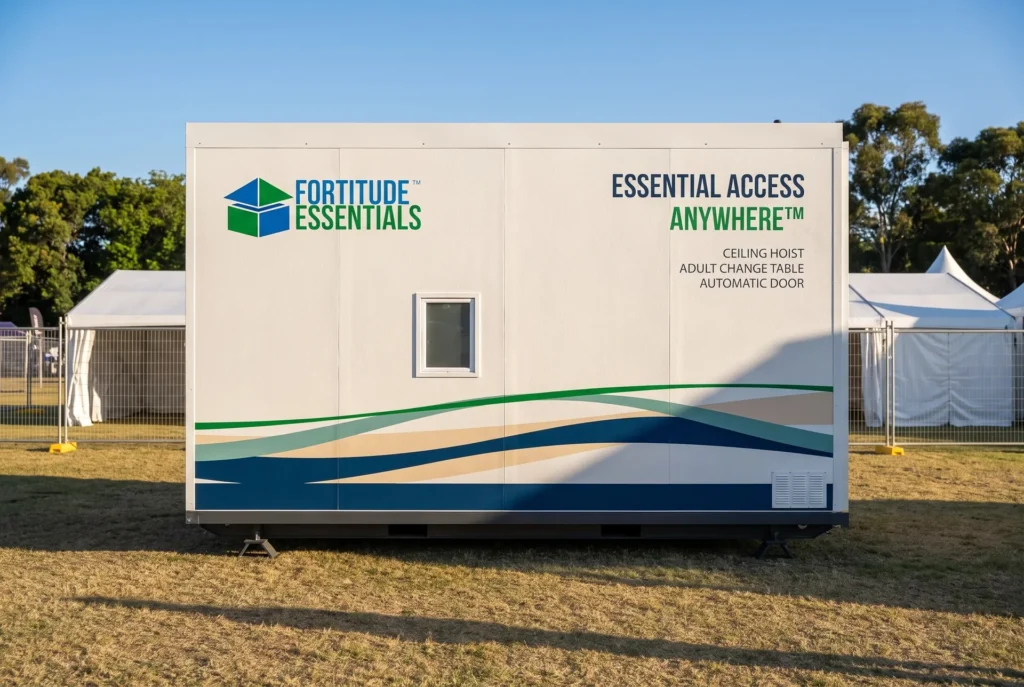 Concept render of the Fortitude Essentials Essential Access Pod, accessible adult change facility, side view at a community event.