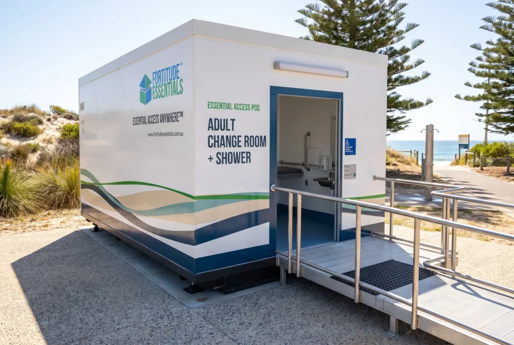 Concept render of the Fortitude Essentials Essential Access Pod, adult change room with shower, exterior front left at a beachfront reserve.