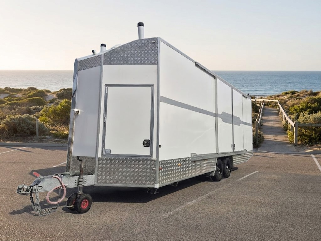 Mobile Access Facility™ in a coastal car park with a beach path and the ocean behind, photograph of the unit with the setting illustrated